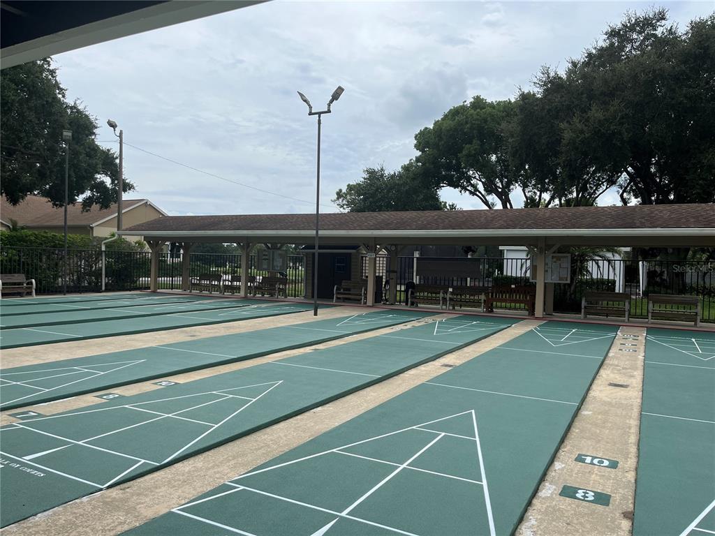 3160 Highlands Boulevard, Unit 3160 Palm Harbor, FL 34684 - Photo 31 of 40 a view of a tennis ground with large trees