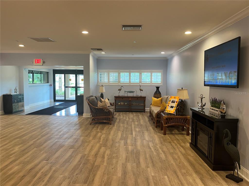 3160 Highlands Boulevard, Unit 3160 Palm Harbor, FL 34684 - Photo 36 of 40 a living room with furniture and wooden floor