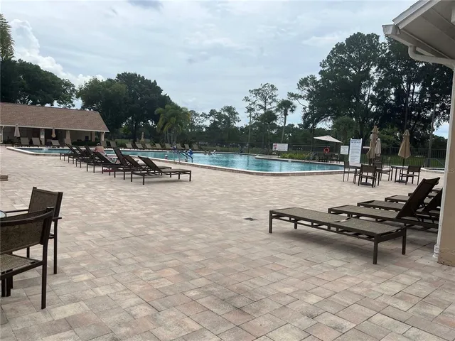an outdoor sitting area with couch and trees