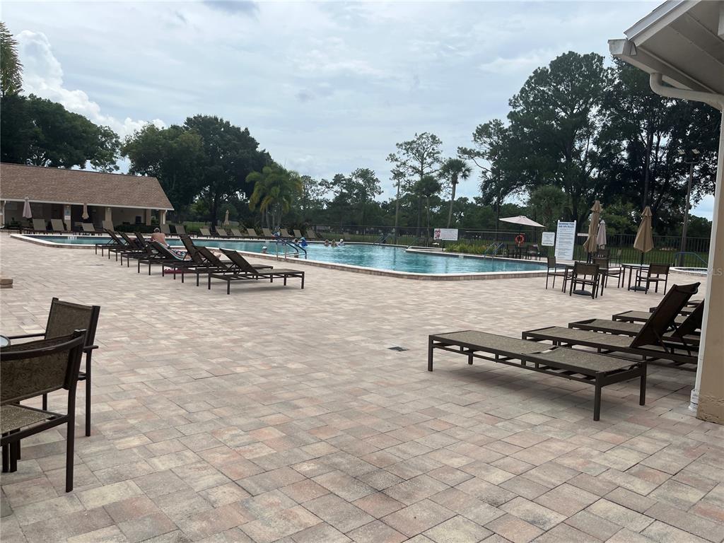 3160 Highlands Boulevard, Unit 3160 Palm Harbor, FL 34684 - Photo 40 of 40 an outdoor sitting area with couch and trees