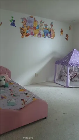 a bedroom with a bed and wall painting on the wall