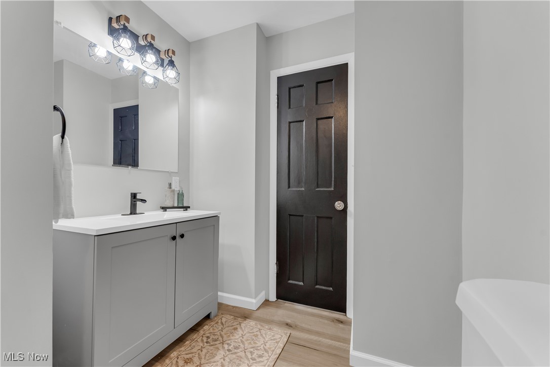 20813 Hansen Road Maple Heights, OH 44137 - Photo 22 of 40 Bathroom with vanity and wood finished floors