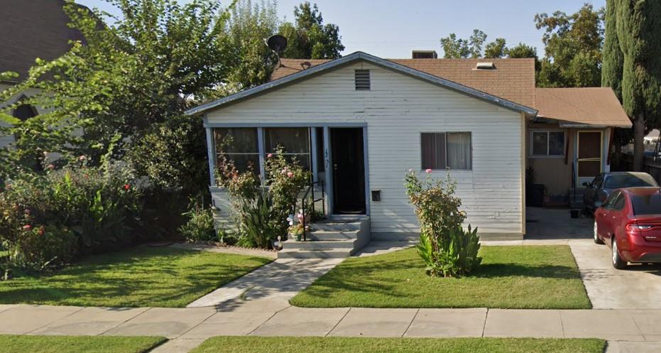 1251 E Street Reedley, CA 93654 - Photo 1 of 1 a front view of a house with garden