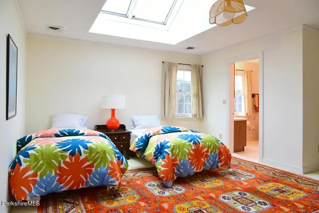 a front view of a house with a yard and trees