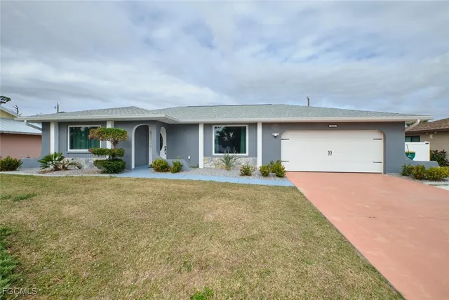 a view of a house with a outdoor space and a yard