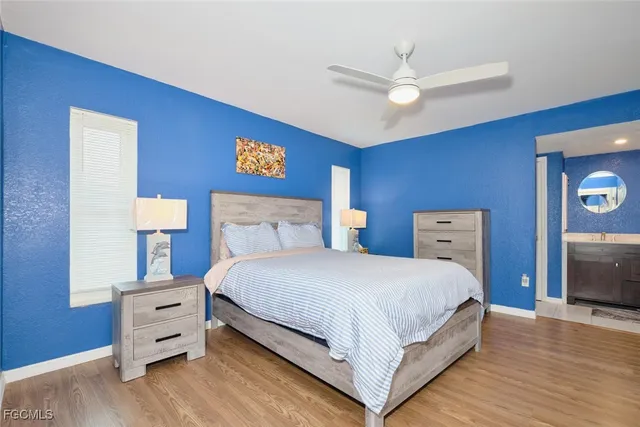 a bedroom with a bed and a ceiling fan