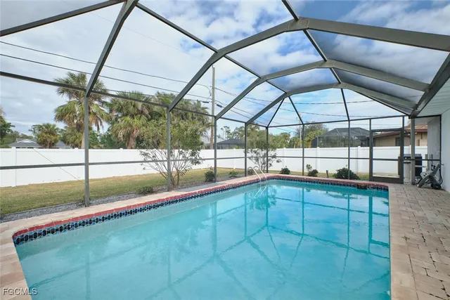 a view of a house with a big yard and large tree