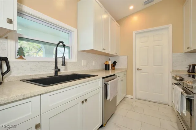 a kitchen with a sink and cabinets