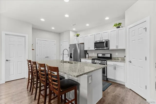 a kitchen with kitchen island granite countertop a table and chairs in it