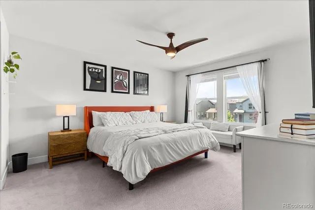 a bedroom with a bed furniture and a large window