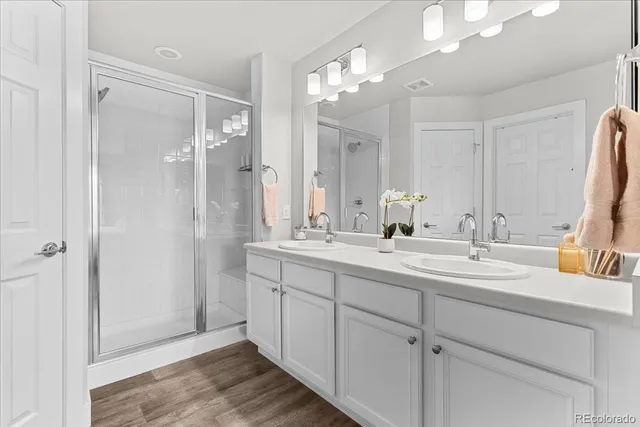 a bathroom with a double vanity sink mirror and double