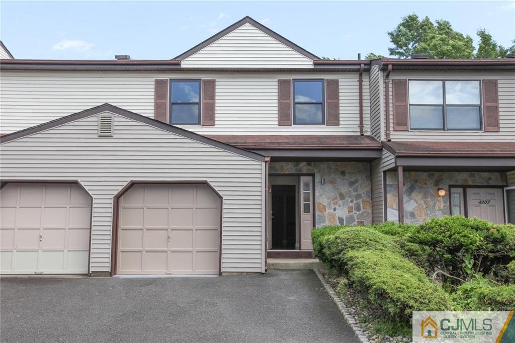 4003 Hana Road Edison, NJ 08817 - Photo 1 of 17 a front view of a house with a garage and balcony