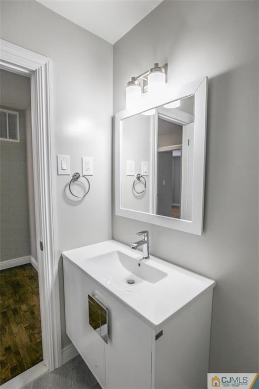 4003 Hana Road Edison, NJ 08817 - Photo 13 of 17 a bathroom with a sink and a mirror