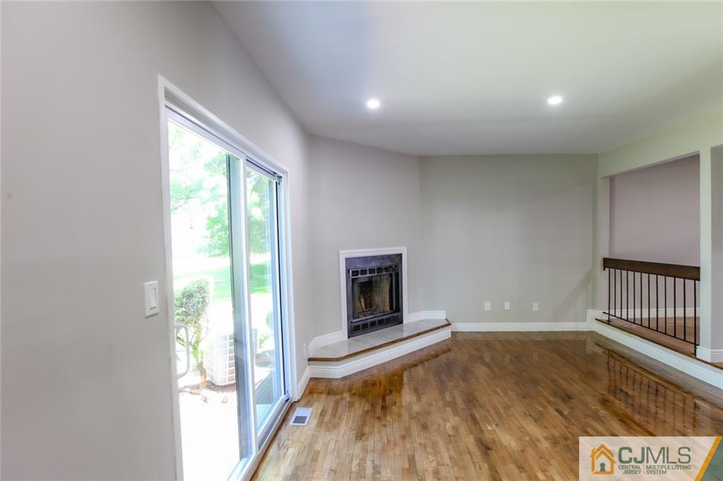 4003 Hana Road Edison, NJ 08817 - Photo 5 of 17 a view of an empty room with a window and wooden floor
