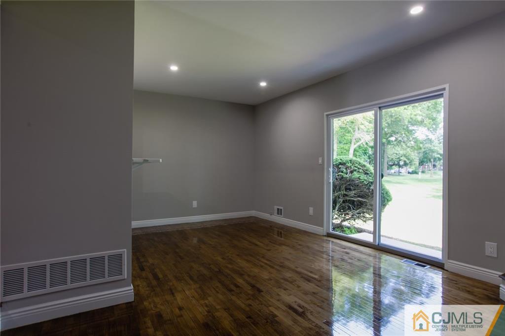4003 Hana Road Edison, NJ 08817 - Photo 7 of 17 a view of empty room with wooden floor and fan