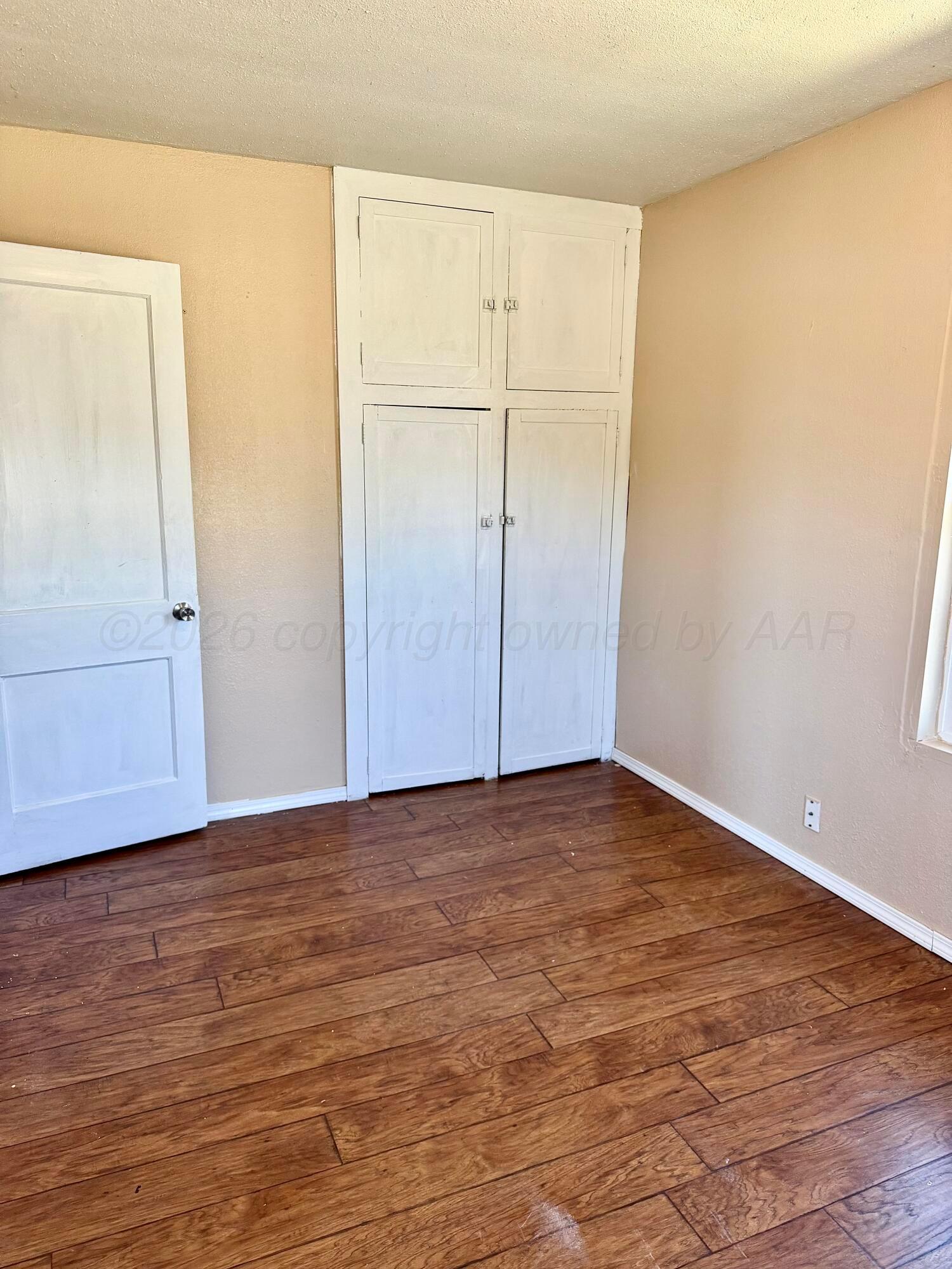 310 Coble Street Borger, TX 79007 - Photo 4 of 7 a view of an empty room with wooden floor