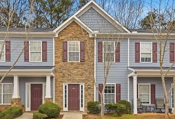 front view of a brick house with a small yard