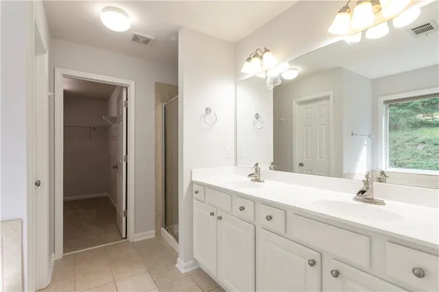 a bathroom with a sink vanity and a mirror