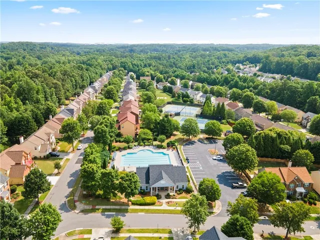 an aerial view of residential houses with outdoor space and street view