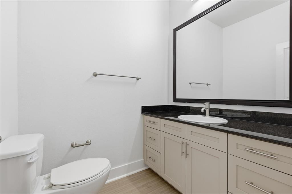 4110 Fairmount Street, Unit 1017 Dallas, TX 75219 - Photo 15 of 35 a bathroom with a granite countertop sink and a mirror