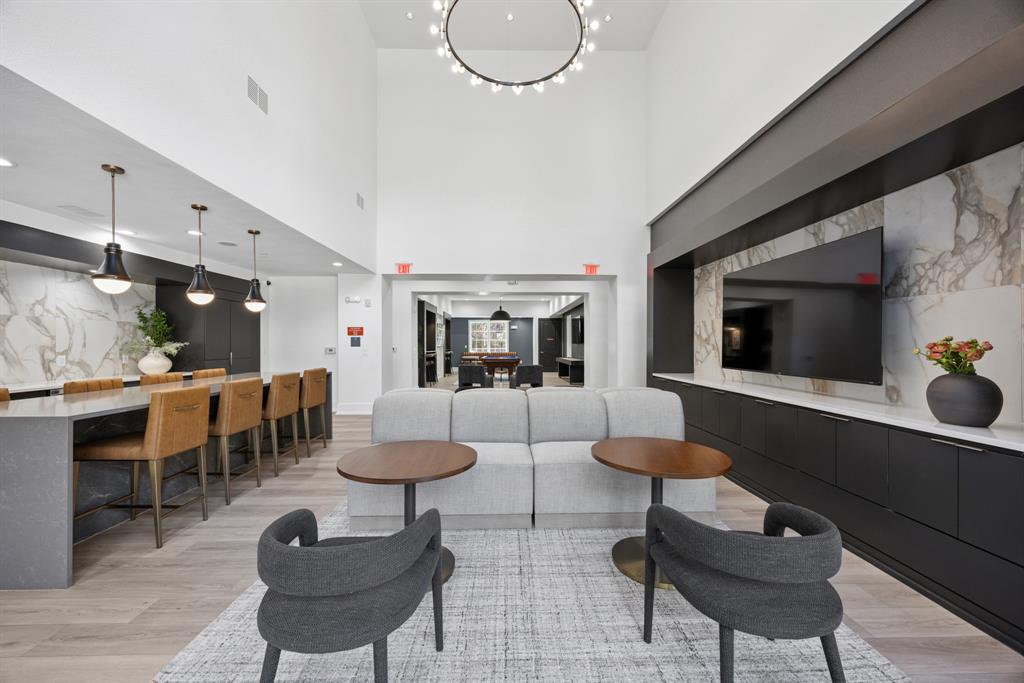 4110 Fairmount Street, Unit 1017 Dallas, TX 75219 - Photo 3 of 35 a living room with furniture a table and kitchen view