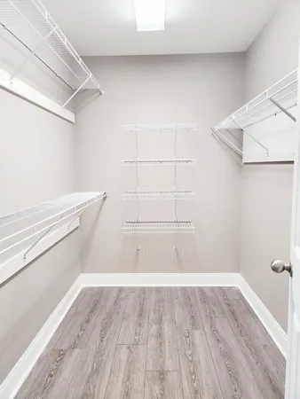 a view of walk in closet with empty racks