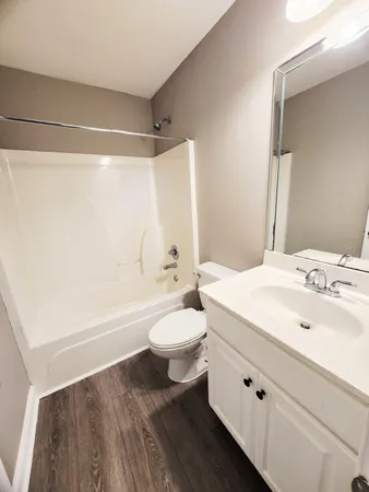 a bathroom with a sink a toilet and a bathtub