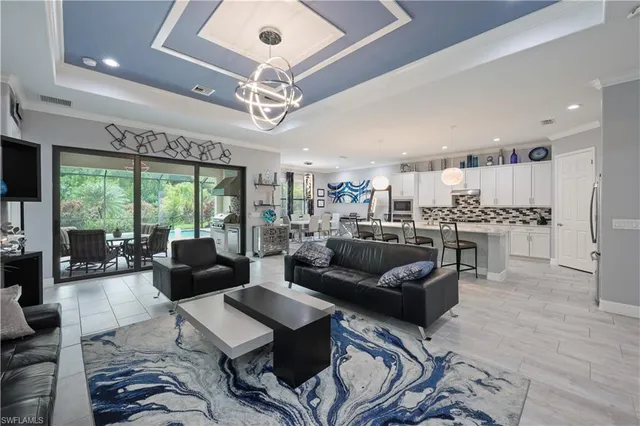 a living room with furniture and a chandelier