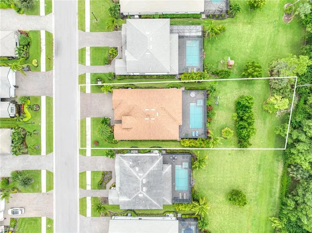 an aerial view of a house with a garden and swimming pool