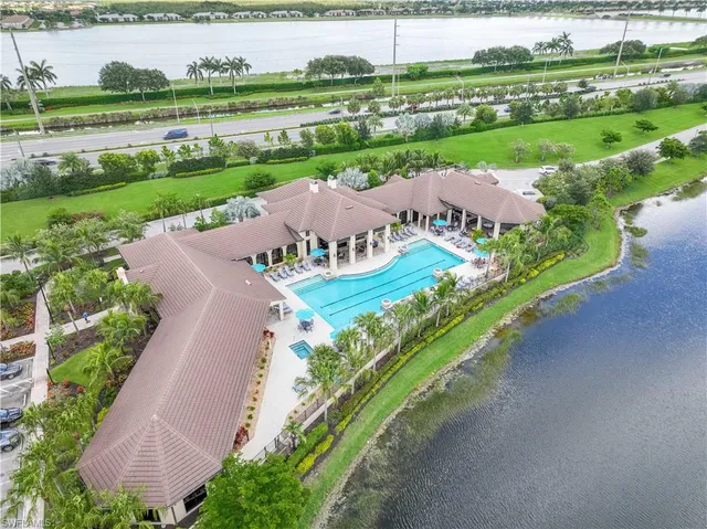 an aerial view of a house with a garden and lake view