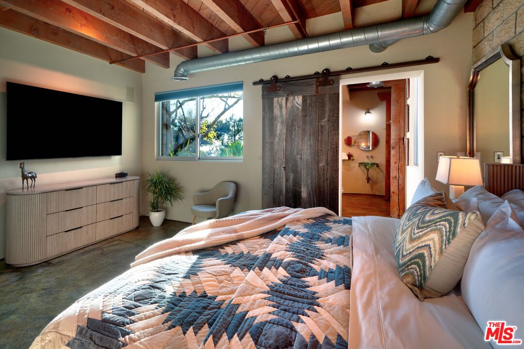3020 Corral Canyon Road Malibu, CA 90265 - Photo 15 of 29 a bedroom with a bed and a flat screen tv