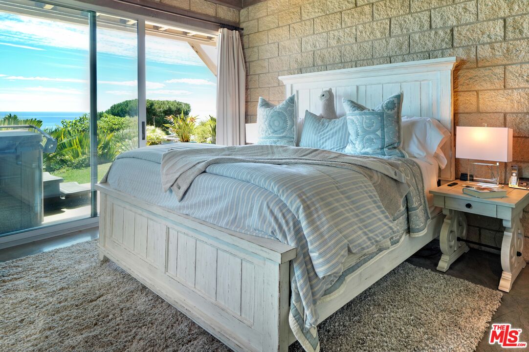 3020 Corral Canyon Road Malibu, CA 90265 - Photo 18 of 29 a bedroom with a bed table flowerpot and window
