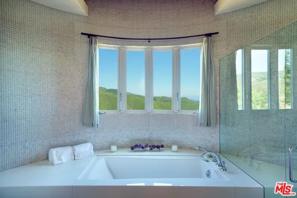 a bathroom with a bathtub and a window