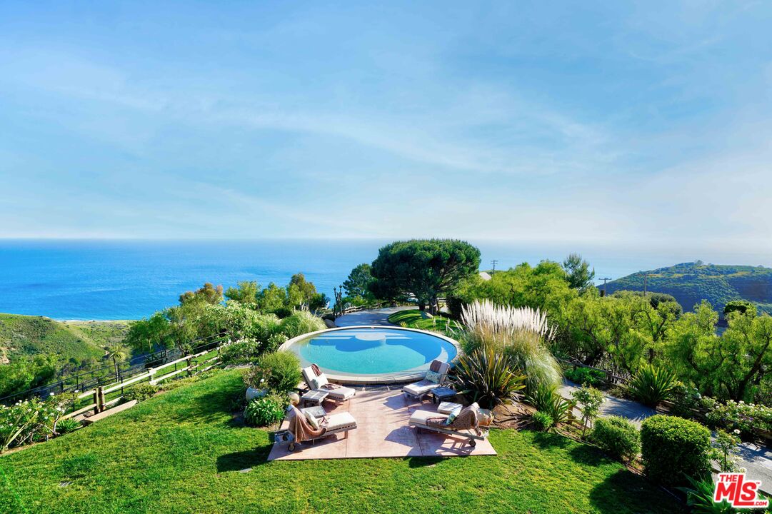 3020 Corral Canyon Road Malibu, CA 90265 - Photo 20 of 29 a swimming pool with outdoor seating and yard