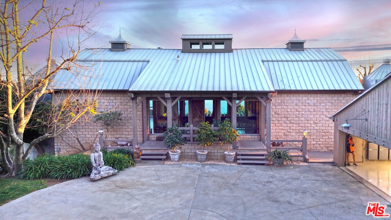 3020 Corral Canyon Road Malibu, CA 90265 - Photo 2 of 29 a front view of a house with garden
