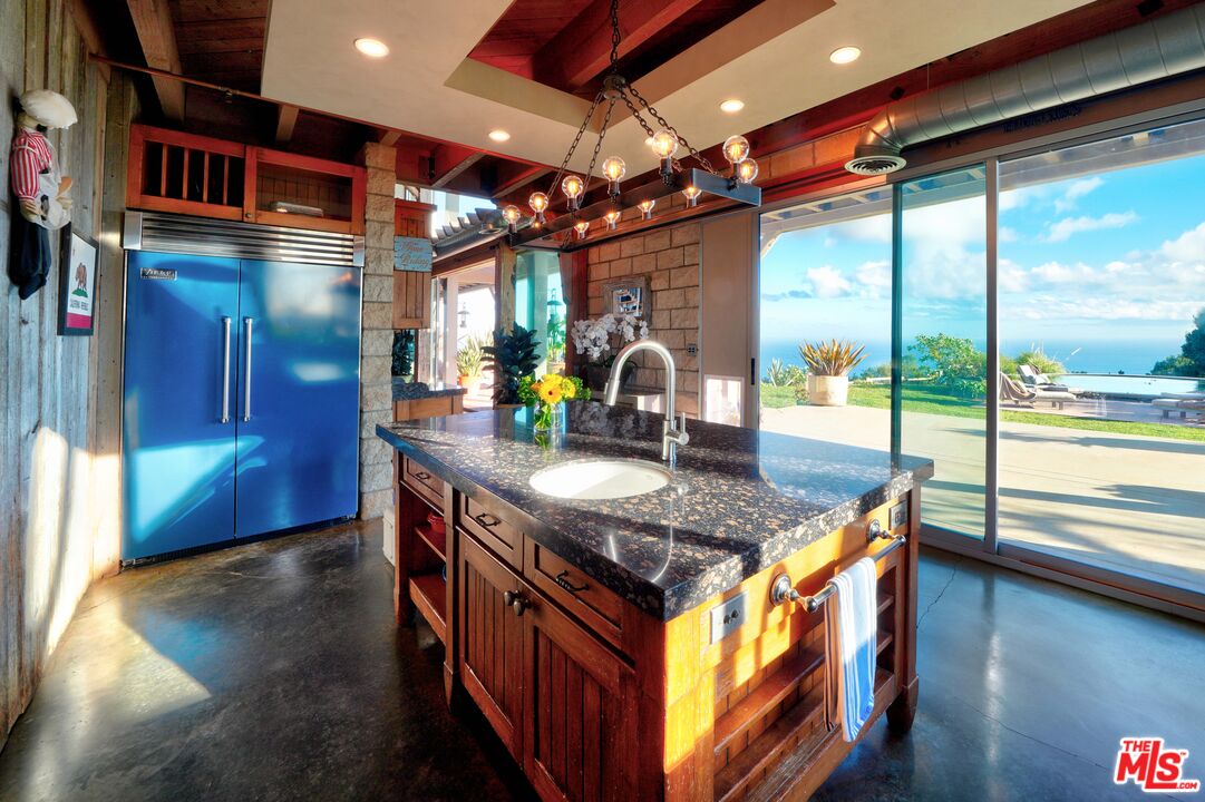 3020 Corral Canyon Road Malibu, CA 90265 - Photo 6 of 29 a kitchen with stainless steel appliances granite countertop a sink a stove and a wooden floors
