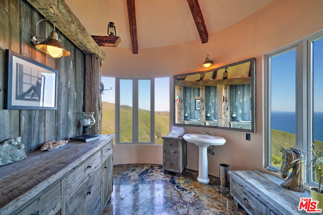 3020 Corral Canyon Road Malibu, CA 90265 - Photo 10 of 29 a spacious bathroom with a granite countertop sink and a mirror