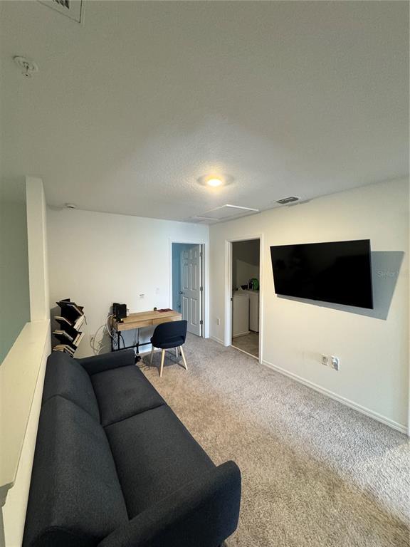 2089 Crape Jasmine Lane Orlando, FL 32824 - Photo 11 of 22 a living room with furniture and a flat screen tv