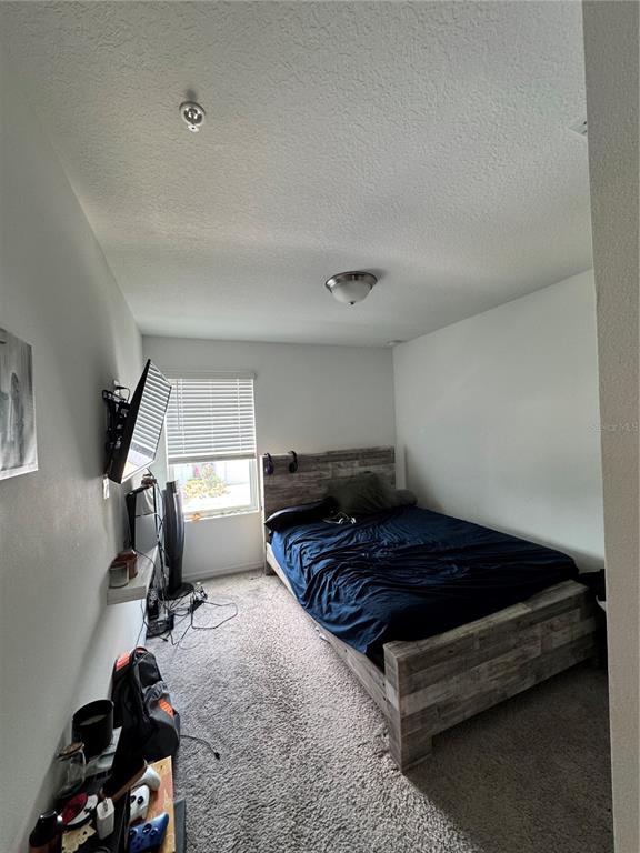 2089 Crape Jasmine Lane Orlando, FL 32824 - Photo 14 of 22 a bedroom with bed and window