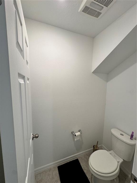 2089 Crape Jasmine Lane Orlando, FL 32824 - Photo 18 of 22 a white toilet sitting next to a shower