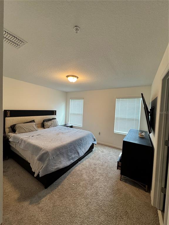 2089 Crape Jasmine Lane Orlando, FL 32824 - Photo 21 of 22 a bedroom with a bed and a couch