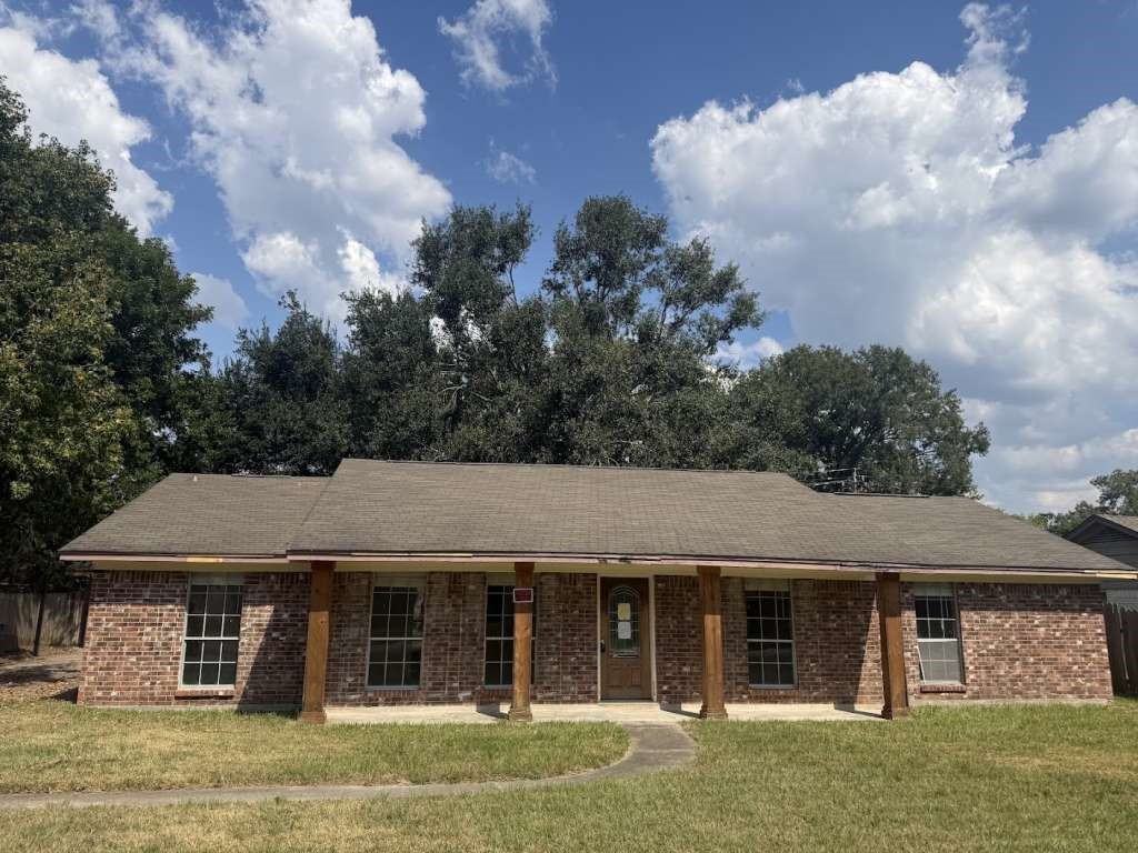 a front view of a house with garden