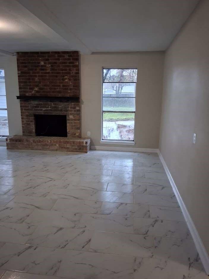 2509 River Ridge Conroe, TX 77385 - Photo 4 of 11 an empty room with windows and fireplace