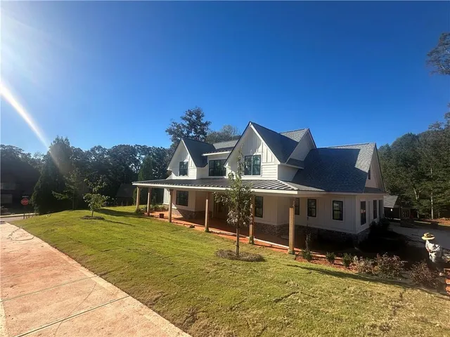 a view of a house with pool in front of it