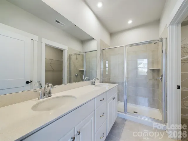 a bathroom with a shower sink double and mirror