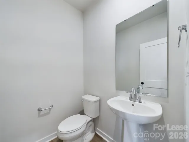 a bathroom with a toilet a sink and a mirror