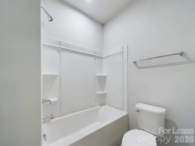 a bathroom with a toilet and a bathtub
