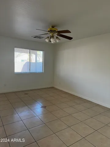 a living room with stainless steel appliances kitchen island granite countertop a sink and cabinets