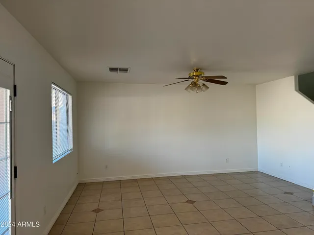 a large kitchen with a large counter top stainless steel appliances and cabinets