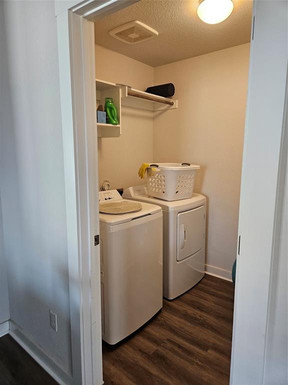 312 Gidran Trail Georgetown, TX 78626 - Photo 13 of 14 Dedicated laundry area featuring wood-finish flooring, overhead built-in shelving, and a garment rod
